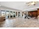 Expansive living room with a wall of windows, tile flooring, a gym bike and a dining area at 436 St Andrews Dr, Belleair, FL 33756