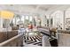 Stylish living room featuring large windows, dark wood floors, and elegant neutral-toned furniture at 436 St Andrews Dr, Belleair, FL 33756