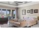 Bright main bedroom featuring a sitting area, elegant decor, and tranquil water views at 436 St Andrews Dr, Belleair, FL 33756