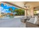 Outdoor patio area with a seating area overlooking a pool with a waterfall and a tropical landscape at 436 St Andrews Dr, Belleair, FL 33756