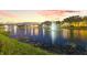 Picturesque pond with illuminated fountains, creating a serene and inviting neighborhood ambiance at 436 St Andrews Dr, Belleair, FL 33756