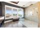 Modern glass enclosed shower with elegant tile work, a bench and serene water views at 436 St Andrews Dr, Belleair, FL 33756