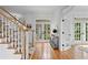 Inviting hallway with hardwood floors, French doors leading to the backyard, and staircase with a patterned runner at 4502 W Culbreath Ave, Tampa, FL 33609