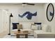 Bright living room featuring a comfortable white couch, modern art, and stylish decor at 4511 S Manhattan Ave # 26, Tampa, FL 33611