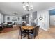 Dining area adjacent to the living room with a wooden table, seating for four, and natural light at 5524 Shasta Daisy Pl, Land O Lakes, FL 34639