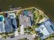 Aerial view of a luxurious waterfront home with a pool and private dock at 5616 Seagrass Pl, Apollo Beach, FL 33572