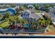 Aerial view of a backyard with a screened pool and tropical landscaping at 5616 Seagrass Pl, Apollo Beach, FL 33572