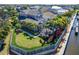 Aerial view of a home with beautiful landscaping and a screened-in pool area at 5616 Seagrass Pl, Apollo Beach, FL 33572