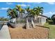 Beautiful backyard featuring a fenced yard, stone retaining wall, and access to the waterfront at 5616 Seagrass Pl, Apollo Beach, FL 33572