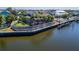Beautiful waterfront backyard, featuring a large pool, dock, and lush landscaping at 5616 Seagrass Pl, Apollo Beach, FL 33572