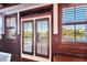 Balcony doors and windows with detailed wood trim and outdoor view at 5616 Seagrass Pl, Apollo Beach, FL 33572