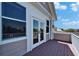 Open balcony featuring French doors with white trim and stained wood decking at 5616 Seagrass Pl, Apollo Beach, FL 33572