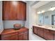 Elegant bathroom with dual vanities, wood cabinets and stylish fixtures at 5616 Seagrass Pl, Apollo Beach, FL 33572