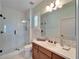 Bathroom featuring a walk-in shower with glass door, wooden vanity, and neutral paint at 5616 Seagrass Pl, Apollo Beach, FL 33572