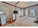 Comfortable bedroom includes a four-poster bed, chandelier, and access to the outside at 5616 Seagrass Pl, Apollo Beach, FL 33572
