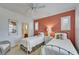 Bedroom with twin beds, an accent wall, and a connecting bathroom at 5616 Seagrass Pl, Apollo Beach, FL 33572