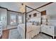 Bedroom boasts a chandelier, four-poster bed, and built-in bench seating at 5616 Seagrass Pl, Apollo Beach, FL 33572