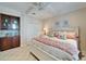 Comfortable bedroom featuring a ceiling fan, artwork, and built-in storage at 5616 Seagrass Pl, Apollo Beach, FL 33572
