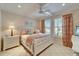 Bright bedroom with a white bed, colorful bedding, and sunlit windows at 5616 Seagrass Pl, Apollo Beach, FL 33572