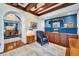 Cozy den with custom built-ins and shelving, plus hardwood floors and access to dining room at 5616 Seagrass Pl, Apollo Beach, FL 33572