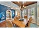Elegant dining area with hardwood floors, wood ceilings and open layout at 5616 Seagrass Pl, Apollo Beach, FL 33572