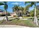 Charming two-story home with a manicured lawn, lush landscaping, and inviting front porch at 5616 Seagrass Pl, Apollo Beach, FL 33572