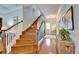 Foyer with staircase, hardwood floors, and a view of the front door at 5616 Seagrass Pl, Apollo Beach, FL 33572
