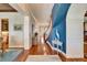 Spacious foyer featuring hardwood floors, stairway and an elegant coastal decorative theme at 5616 Seagrass Pl, Apollo Beach, FL 33572