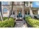 Inviting front porch with blue door, brick pathway, lush landscaping, and white railings at 5616 Seagrass Pl, Apollo Beach, FL 33572