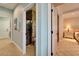 Hallway leading to a bathroom and bedroom with decorative artwork at 5616 Seagrass Pl, Apollo Beach, FL 33572