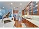 Bright kitchen featuring wood cabinets, stainless appliances, hardwood floors and quartz countertops at 5616 Seagrass Pl, Apollo Beach, FL 33572