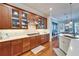 Kitchen with wood cabinets, stainless appliances, quartz countertops, and hardwood floors at 5616 Seagrass Pl, Apollo Beach, FL 33572