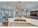 Kitchen with a center island and stainless sink opens to the eating area at 5616 Seagrass Pl, Apollo Beach, FL 33572