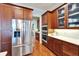 Kitchen with stainless steel refrigerator, double oven, hardwood floors, and wood cabinets at 5616 Seagrass Pl, Apollo Beach, FL 33572
