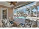 Spacious lanai with comfortable seating, overlooking the pool, lush landscaping, and spa at 5616 Seagrass Pl, Apollo Beach, FL 33572