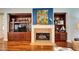 Living room with a fireplace and built-in wooden cabinets at 5616 Seagrass Pl, Apollo Beach, FL 33572
