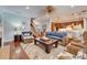 Open-concept living room with hardwood floors and seamless access to the kitchen and staircase at 5616 Seagrass Pl, Apollo Beach, FL 33572