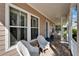 Inviting covered patio with wicker chairs and shuttered windows for relaxing outdoors at 5616 Seagrass Pl, Apollo Beach, FL 33572