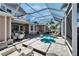 Outdoor screened pool area with spa, patio, and plenty of seating around at 5616 Seagrass Pl, Apollo Beach, FL 33572