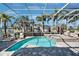 Screened pool area with a spa, outdoor seating, and well-maintained landscaping at 5616 Seagrass Pl, Apollo Beach, FL 33572