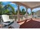 Inviting porch with comfortable seating and a view of lush tropical landscaping at 5616 Seagrass Pl, Apollo Beach, FL 33572