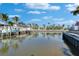 Scenic waterfront view displaying docks, boats, and beautiful waterfront homes under a blue sky at 5616 Seagrass Pl, Apollo Beach, FL 33572