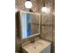 A bathroom featuring vintage floral wallpaper, vanity, sink, faucet, and mirror at 5750 80Th N St # A106, St Petersburg, FL 33709