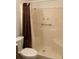 A full bathroom with a shower featuring a shower curtain, seat, and safety bar at 5750 80Th N St # A106, St Petersburg, FL 33709