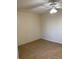 A bedroom featuring tile floors, a window with blinds, and a ceiling fan at 5750 80Th N St # A106, St Petersburg, FL 33709