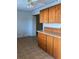 A kitchen featuring wooden cabinets, a ceiling fan, and a vintage-style floor at 5750 80Th N St # A106, St Petersburg, FL 33709