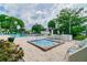Community pool with a hot tub, sun chairs, and lots of palm trees; the perfect place to relax and cool off at 5750 80Th N St # A106, St Petersburg, FL 33709