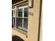A close-up view of window with white shutters featuring the unit number '106' on the exterior wall at 5750 80Th N St # A106, St Petersburg, FL 33709