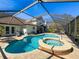 Screened in-ground pool with spa and brick paver deck at 5827 Fieldspring Ave, New Port Richey, FL 34655