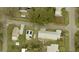 An aerial view showcases a quaint home with solar panels and lush landscaping at 6103 Anna Ave, Gibsonton, FL 33534